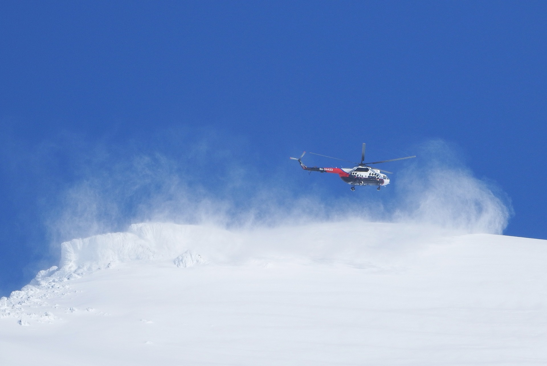 helicopter in flight above snow