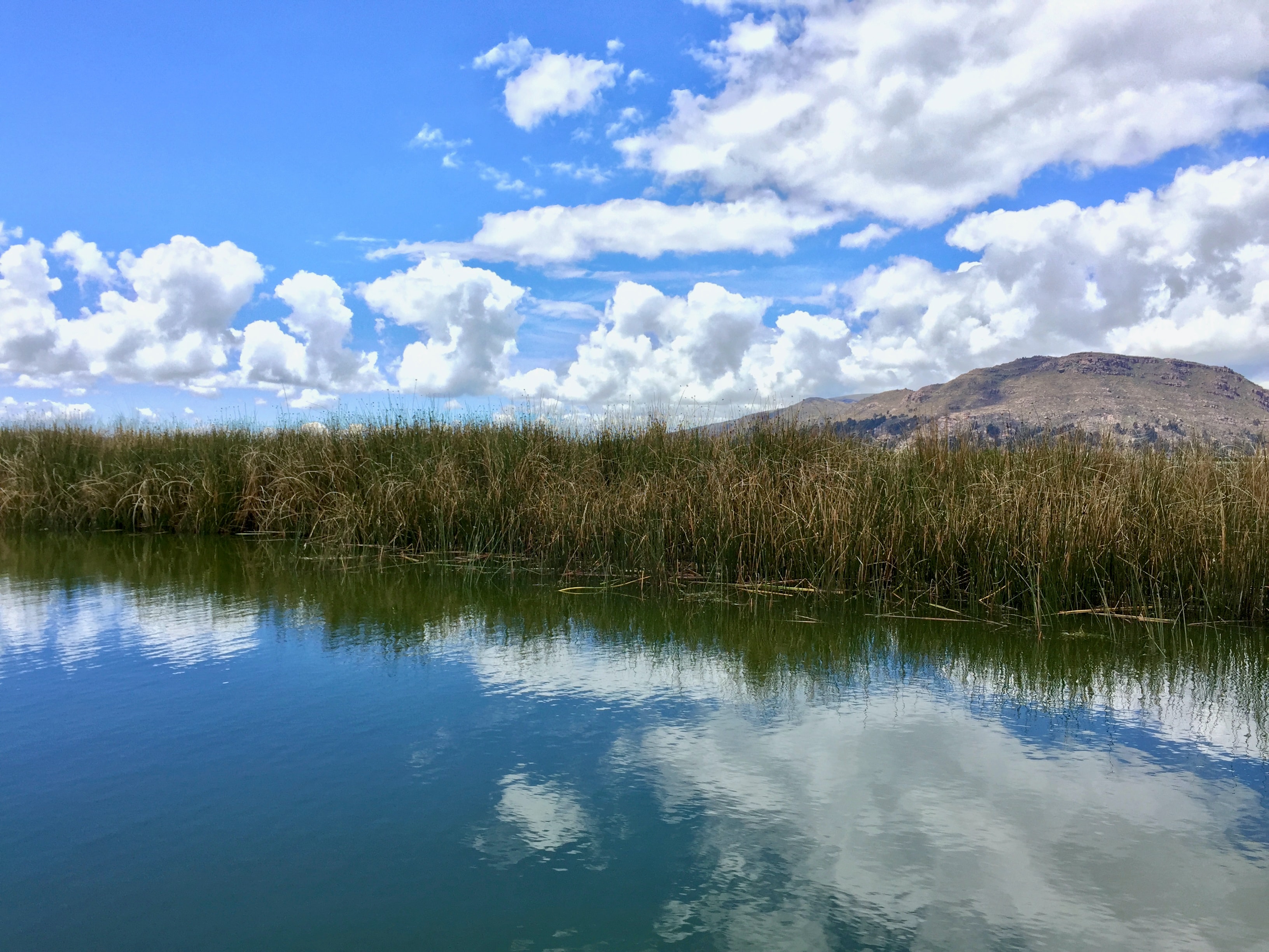 altocumulus castellanus clouds above the mountain and water surface