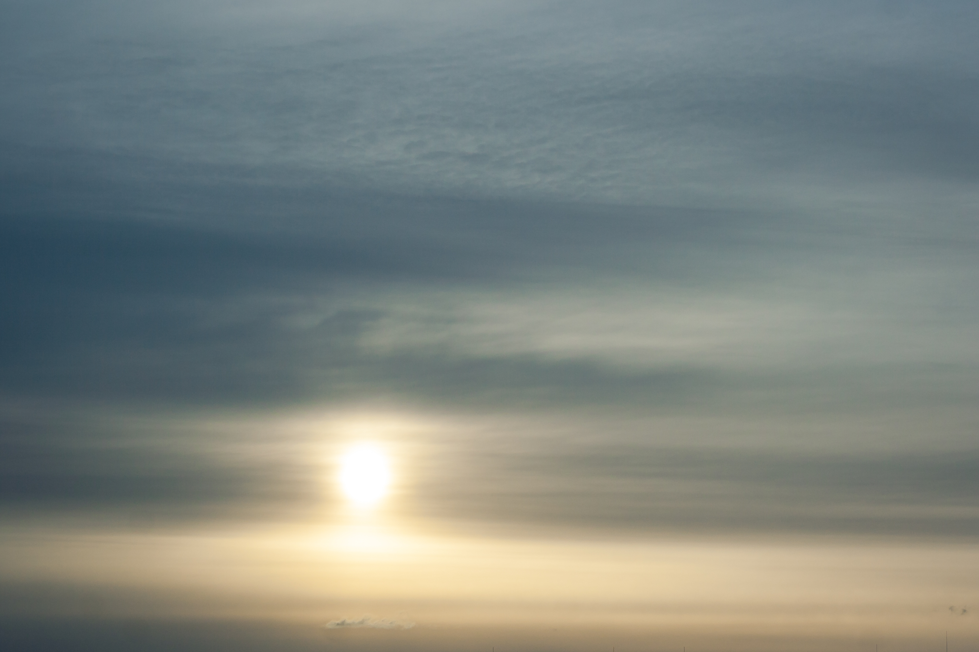 sun filtering through a layer of altostratus cloud