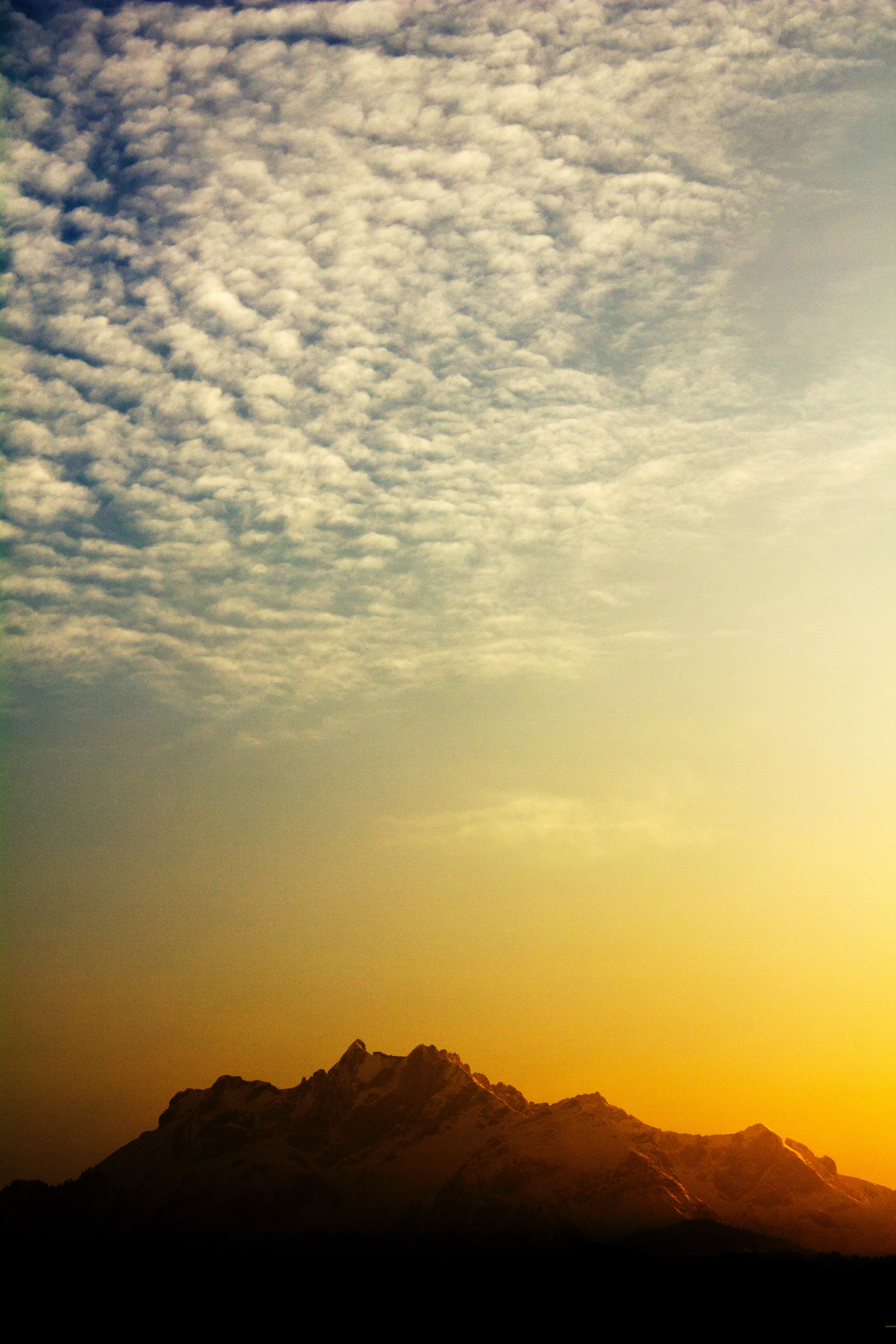 cirrocumulus clouds above the mountain in the sunset