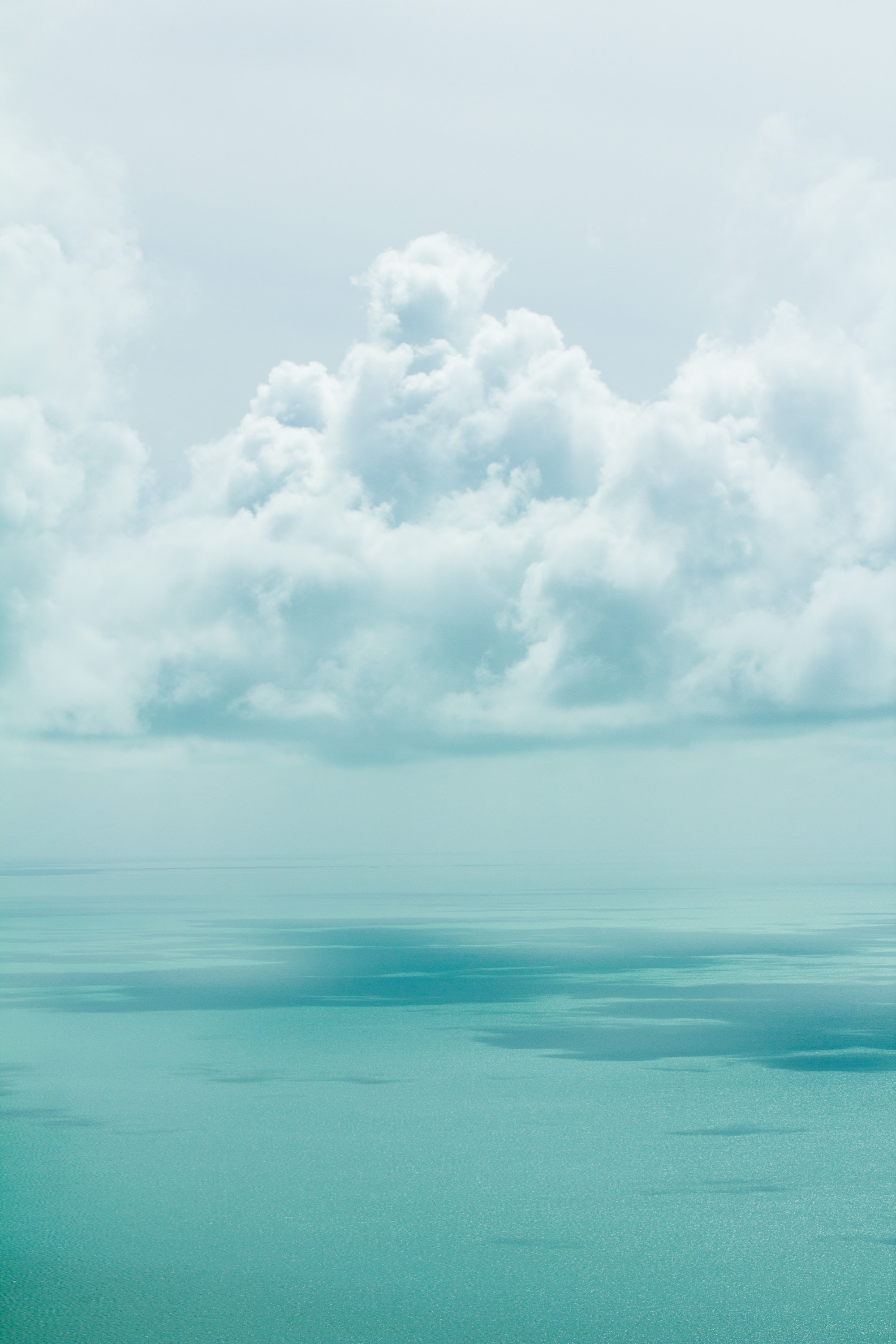 towering cumulus clouds above the sea