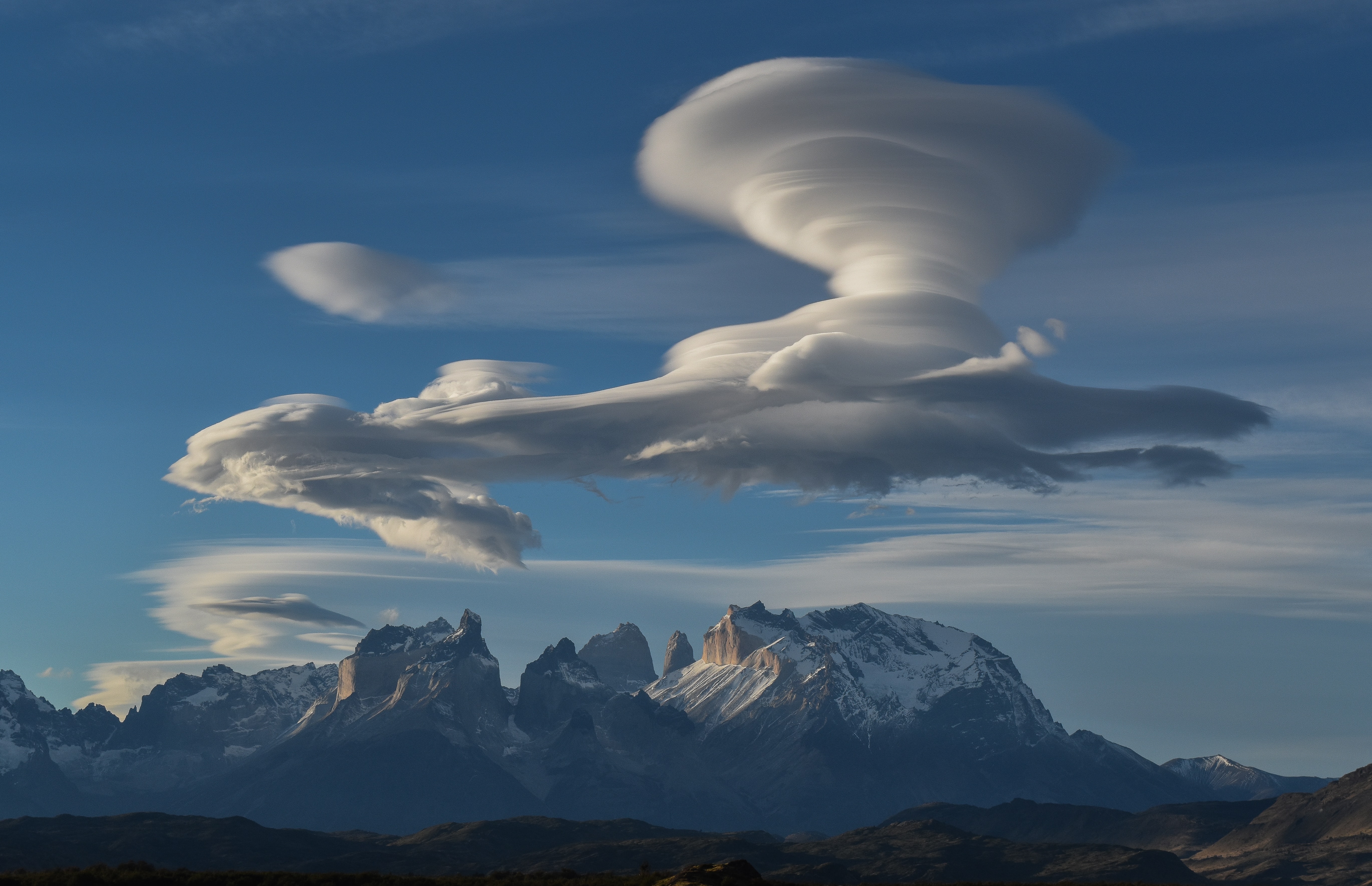 lenticular clouds over mountains